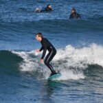 Jackson Prudhon riding a wave next to Morro Rock.