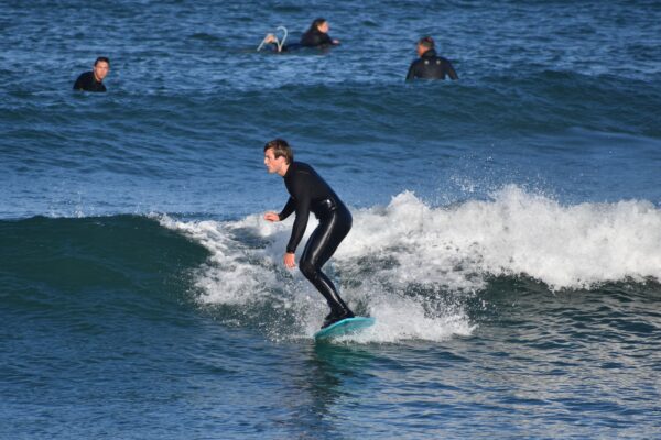 Jackson Prudhon riding a wave next to Morro Rock.