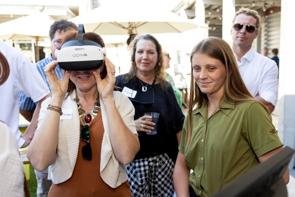 A woman wears a headset used to detect concussions