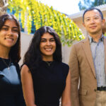 Outdoor portrait of two students with faculty mentor