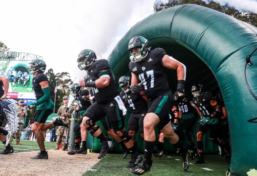 Football players charge onto the field